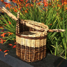 Modern one sided asymmetric handbag style basket with long branch handle. 28cm H x 20cm W (41cm W with handle)