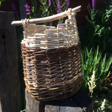 Modern double sided asymmetric handbag style basket with treated wooden handle. 27cm H x 22cm W (26cm incl. handle)